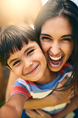 Buy stock photo Closeup portrait of an attractive young woman and her young son outside