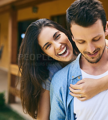 Buy stock photo Cropped portrait of an affectionate young couple standing outside with their house in the background