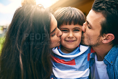 Buy stock photo Cropped shot of a young mother and father kissing their son while outside in their yard