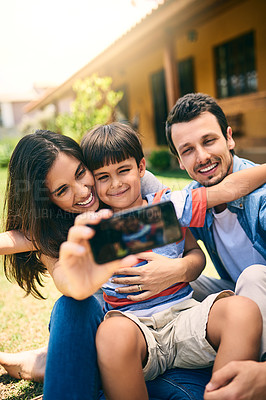 Buy stock photo Happy family, relax and smile for selfie, profile picture or photo in social media vlog outside home. Mother, father and child smiling for fun memory, online post or holiday weekend break together