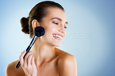 Buy stock photo Happy, makeup and woman with brush in studio and proud with tools for beauty and apply powder. Blue background, space and girl with product for application of cosmetics, skin and relax in salon