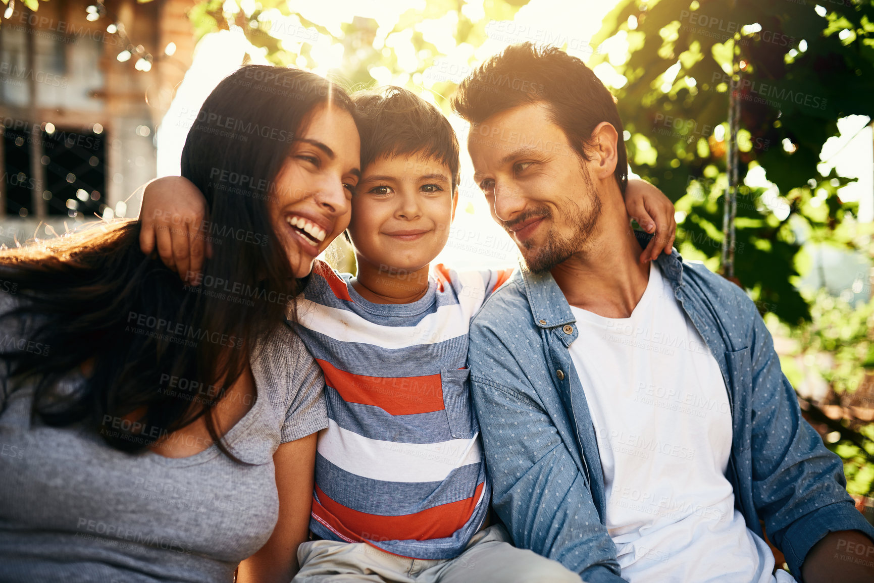 Buy stock photo Portrait of an adorable little boy bonding with his parents outdoors