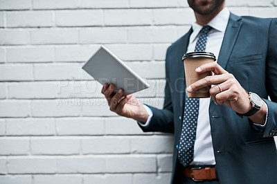 Buy stock photo Closeup shot of an unidentifiable businessman using a digital tablet outdoors