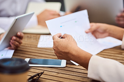 Buy stock photo Cropped shot of an unrecognizable young businesswoman reading paperwork during a meeting in the boardroom