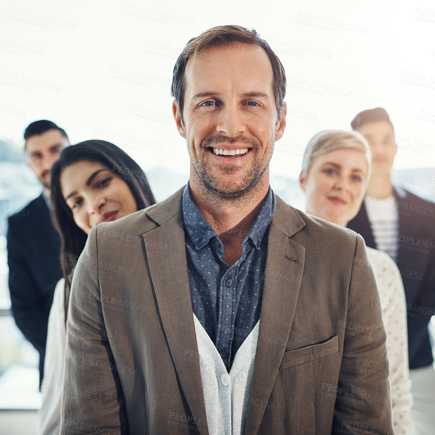 Buy stock photo Portrait of a diverse group of businesspeople standing in a line in an office