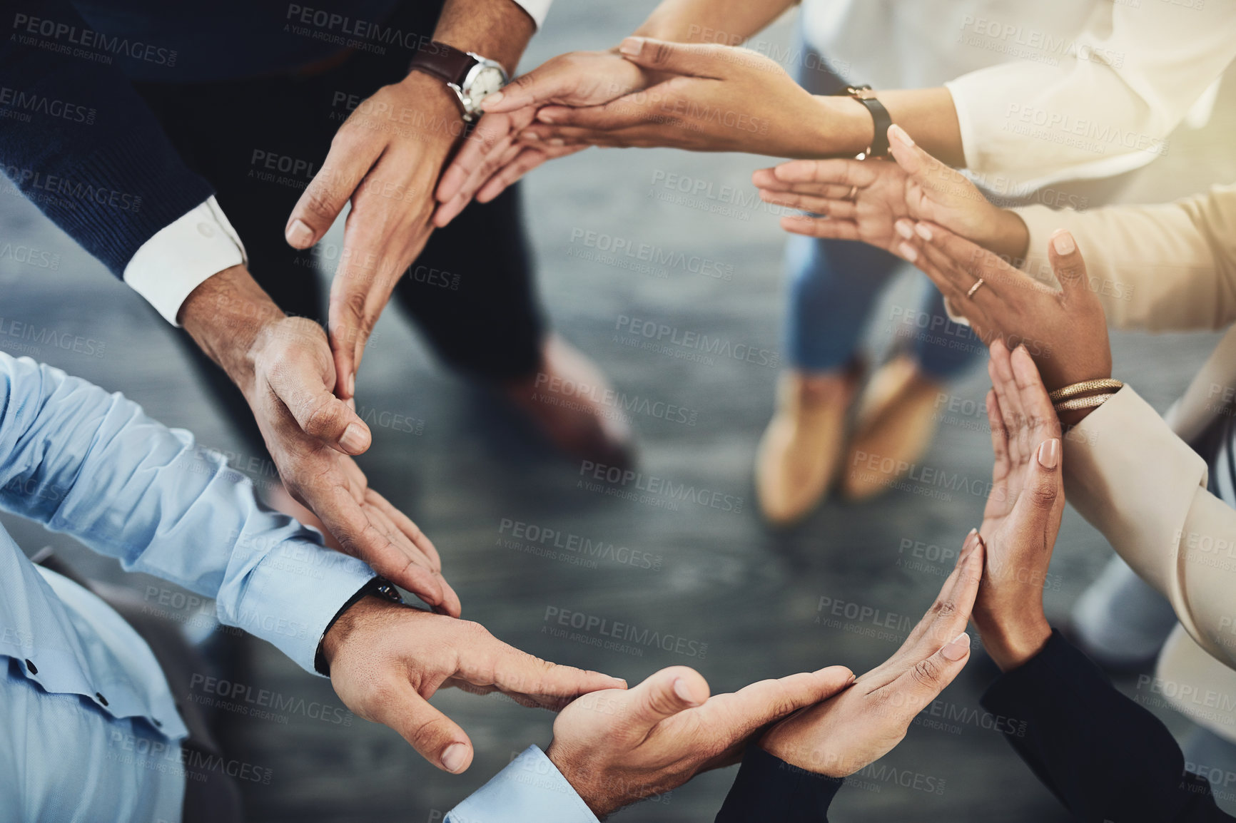 Buy stock photo Circle of hands, teamwork and togetherness with a group of business colleagues standing in a team huddle from above. Working together, showing unity and giving support in a meeting for motivation