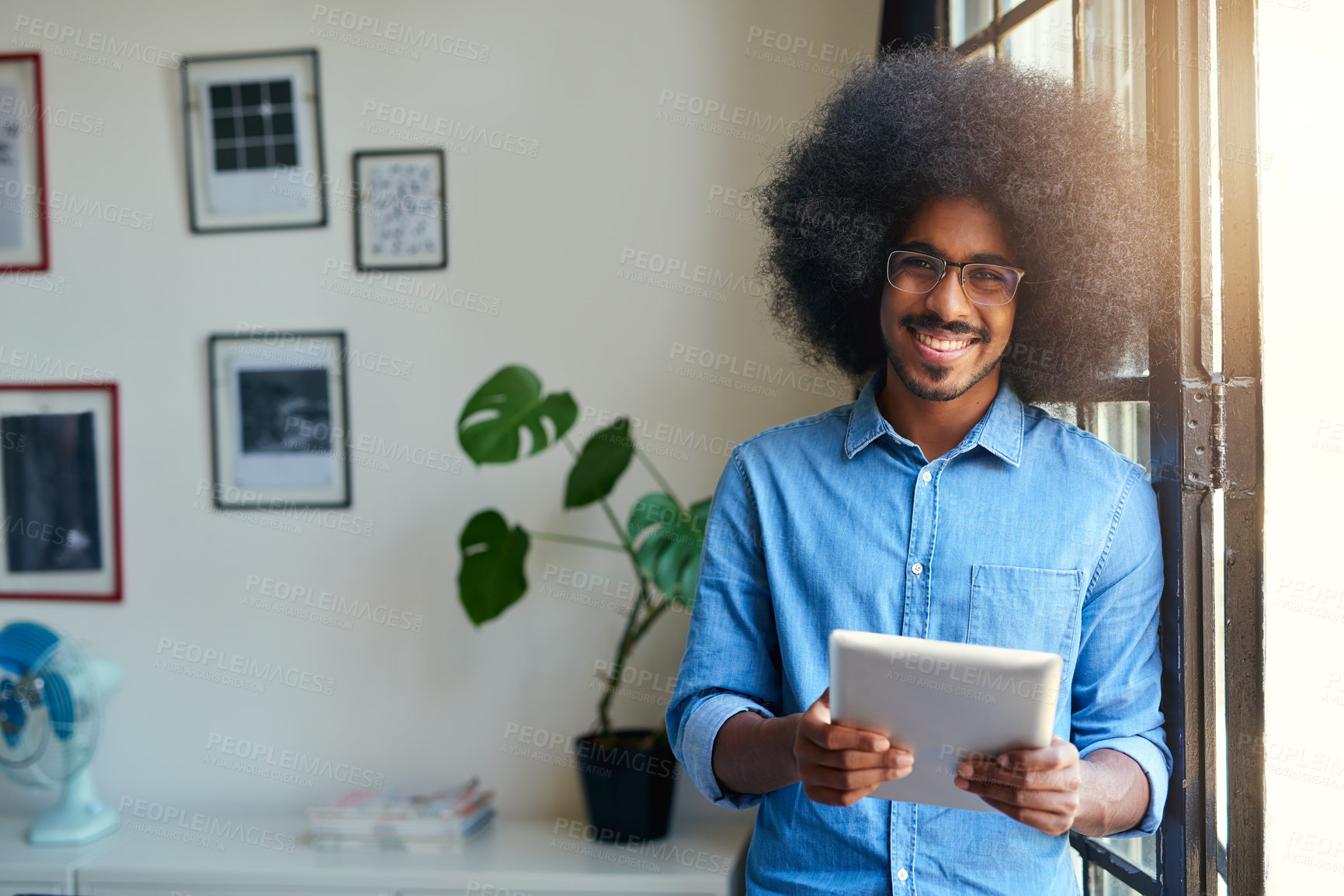 Buy stock photo Portrait, smile and tablet with designer man in creative workplace for administration or web development. Creative, glasses and leaning with happy African person at design office window for career