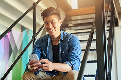 Buy stock photo Asian man, office stairs and texting with phone in portrait with chat, smile and social network app. Young japanese creative, web design startup and relax on steps in workplace, contact and cellphone