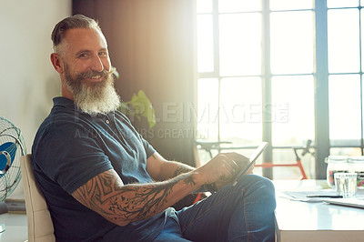 Buy stock photo Cropped portrait of a handsome mature male designer working on a tablet in his office