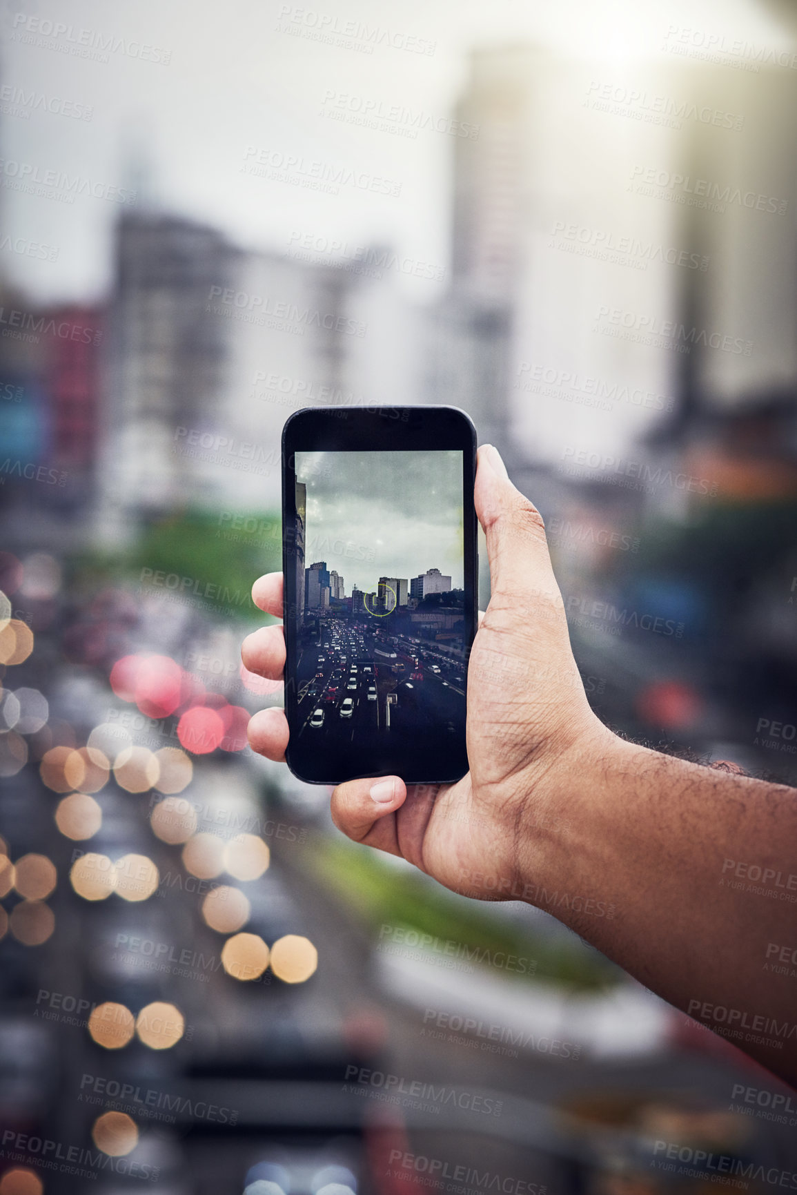 Buy stock photo Cropped shot of an unrecognizable man taking a picture with a cellphone in the city