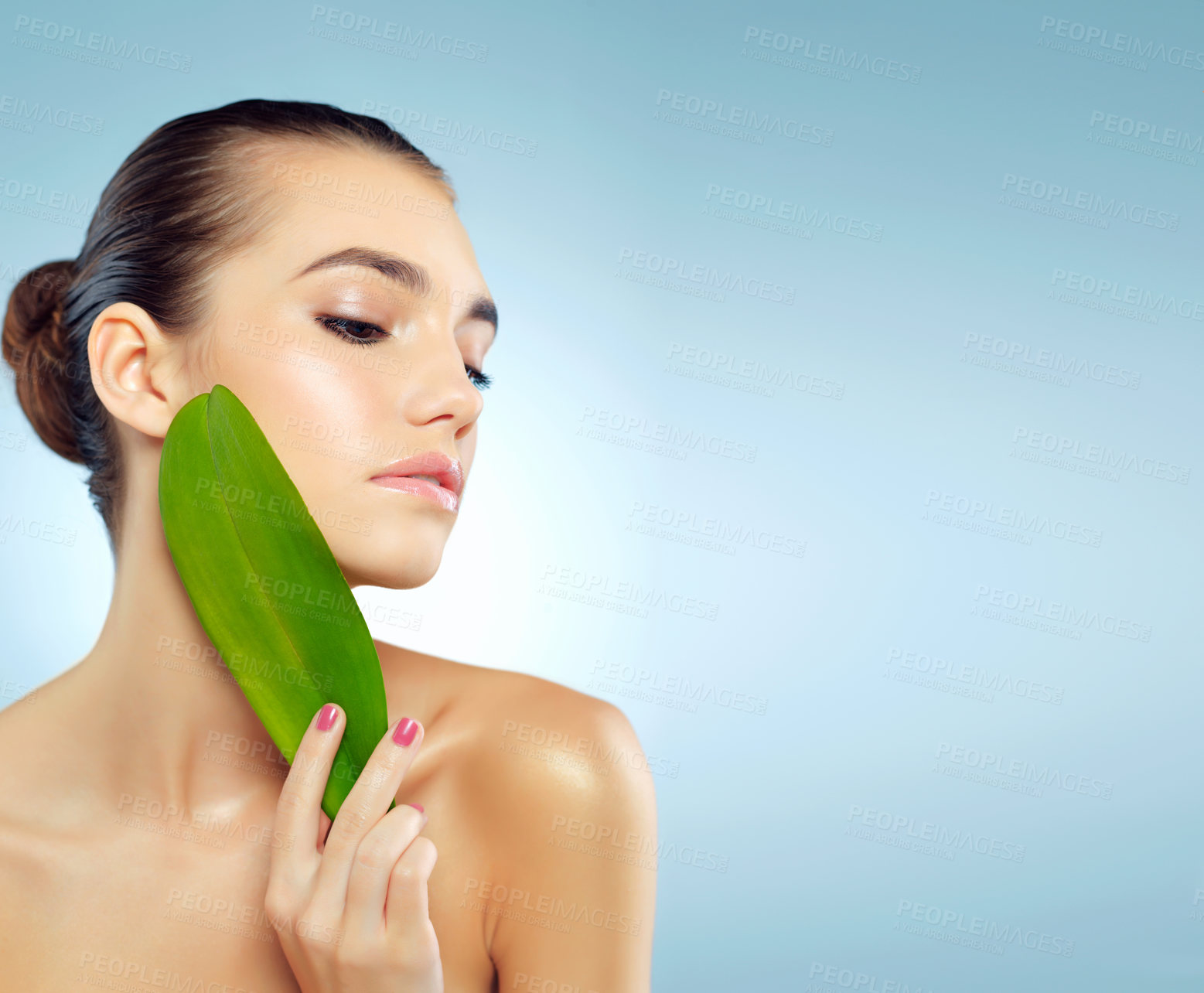 Buy stock photo Girl, thinking and leaf in studio for skincare or natural dermatology, organic treatment and ingredient for cosmetics. Woman, blue background and leave for sensitive skin, anti aging and mock up.