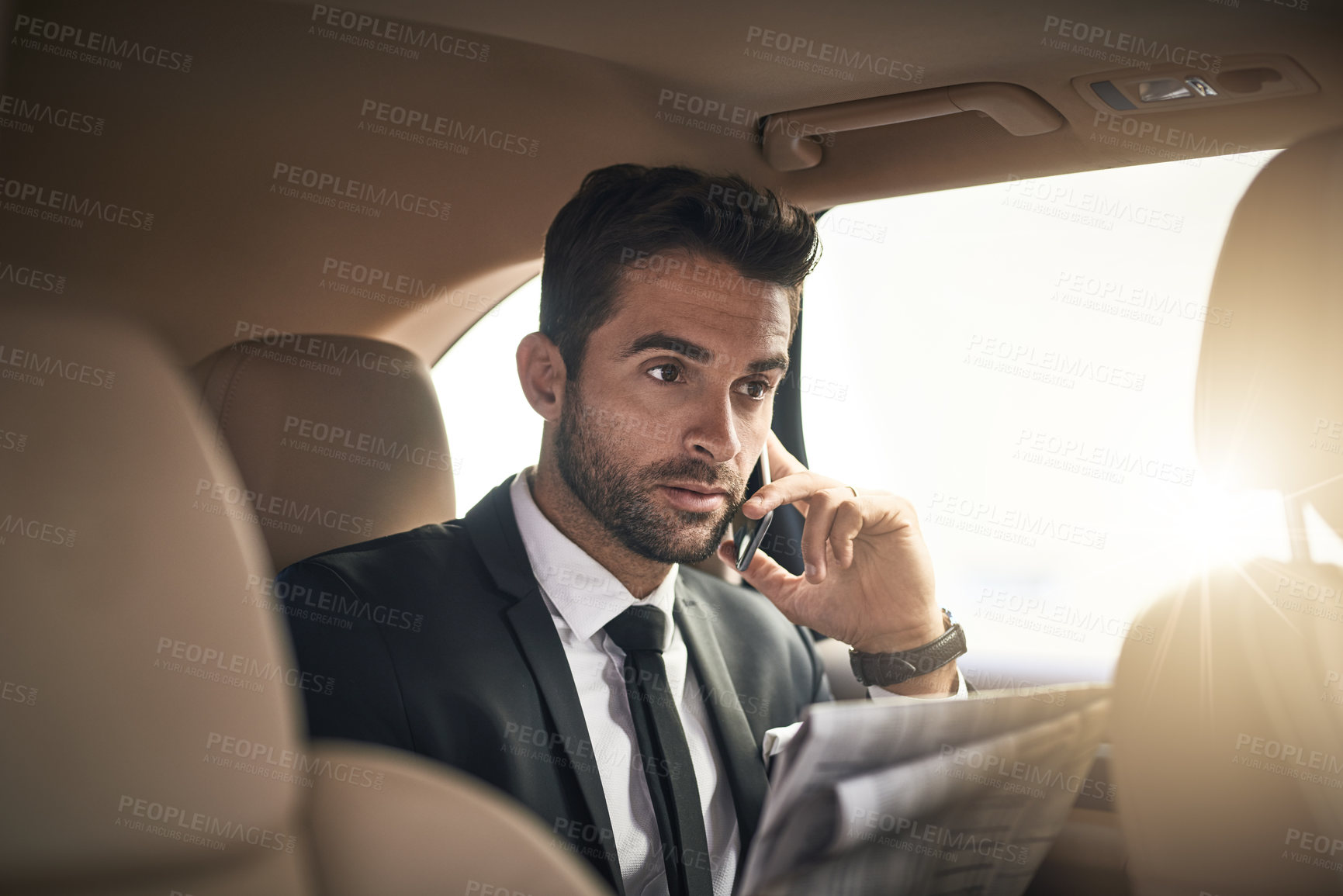 Buy stock photo Businessman, newspaper and reading in transport with phone call for career, meeting or conversation. Male person, car and commute on mobile tech as professional or investment banker for luxury travel