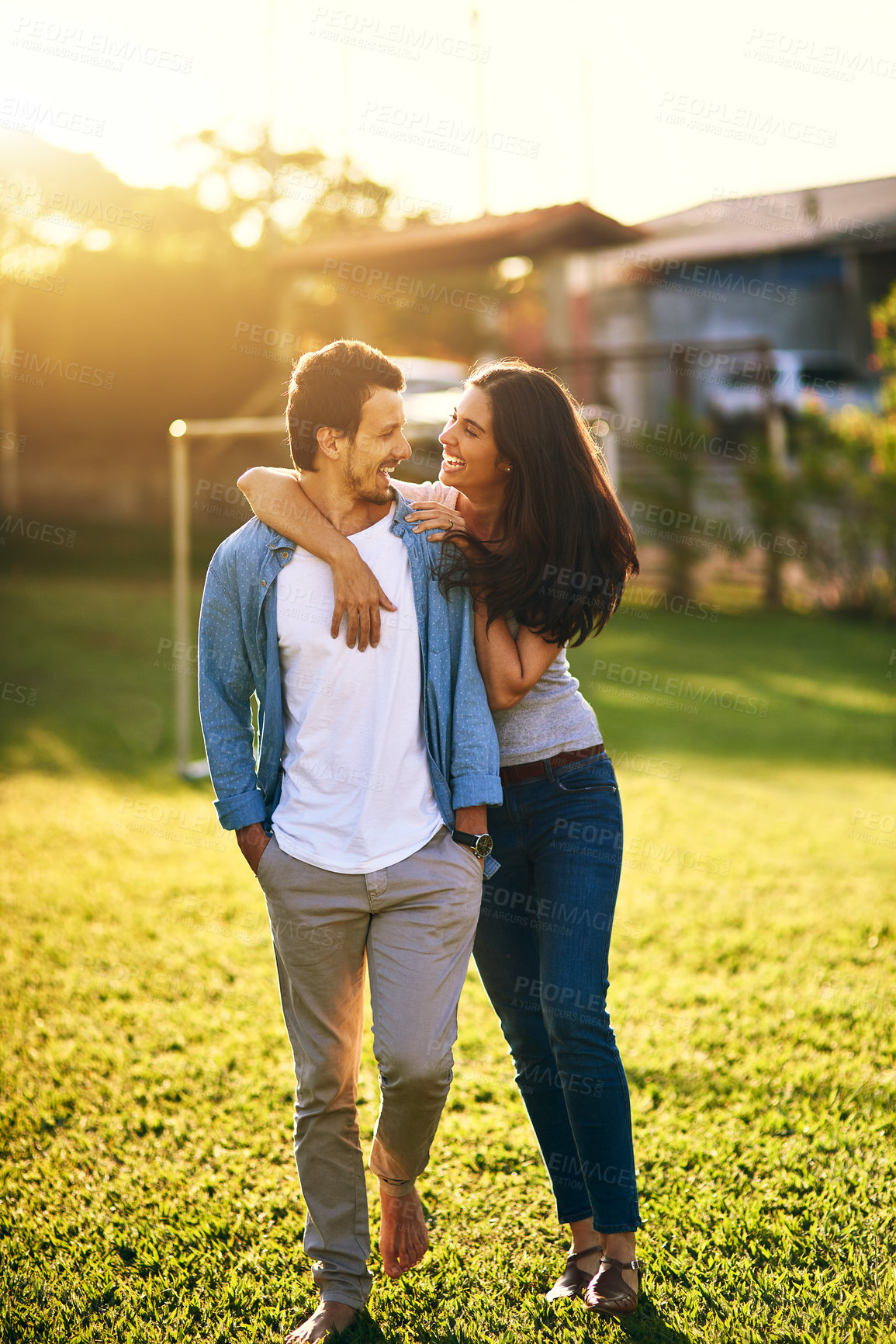 Buy stock photo Shot of an affectionate young couple bonding together outdoors