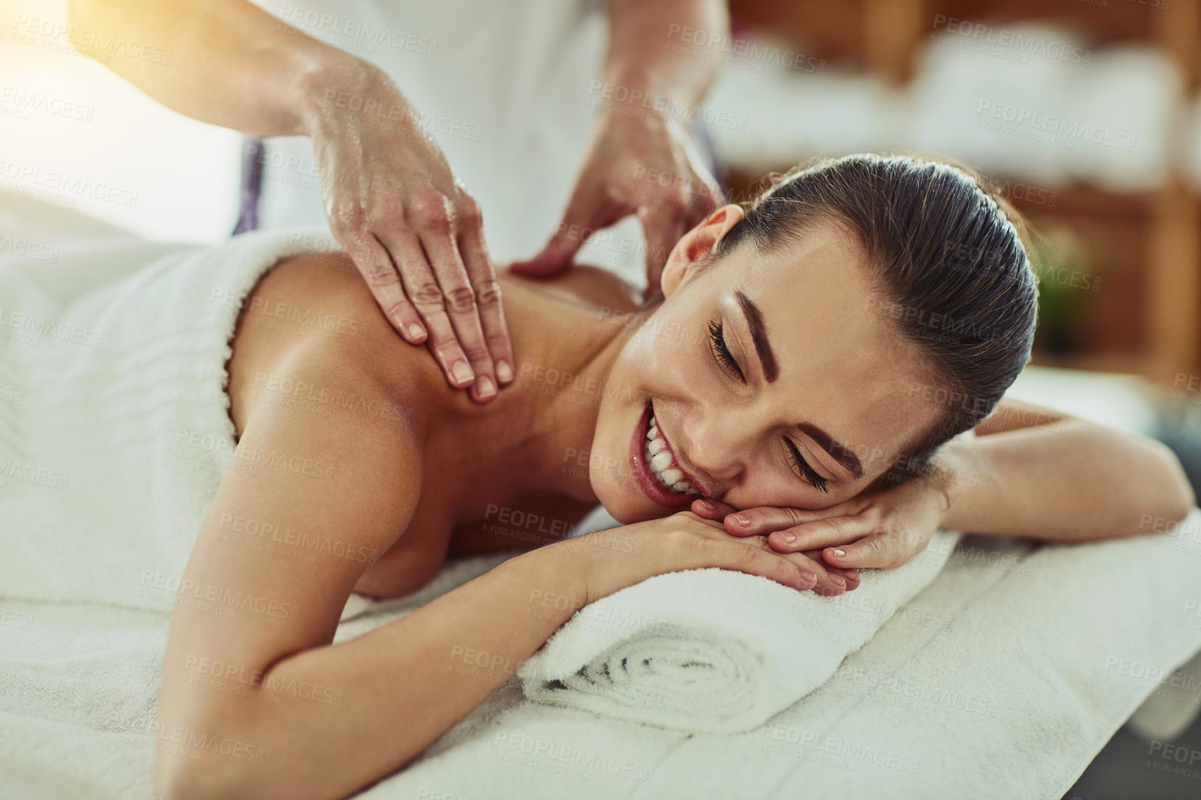 Buy stock photo Shot of an attractive young woman getting massaged at a beauty spa