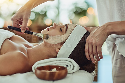 Buy stock photo Shot of an attractive young woman getting a facial at a beauty spa