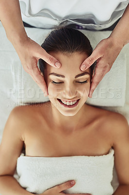 Buy stock photo Shot of an attractive young woman getting massaged at a beauty spa