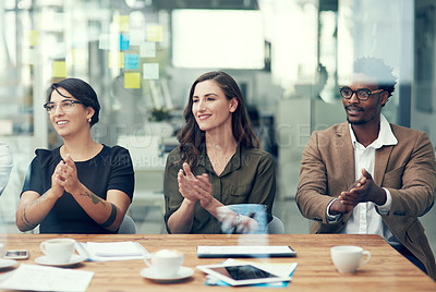 Buy stock photo Shot of a group of businesspeople applauding in an office