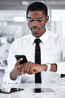 Buy stock photo Cropped shot of a handsome young businessman using smartglasses in his office