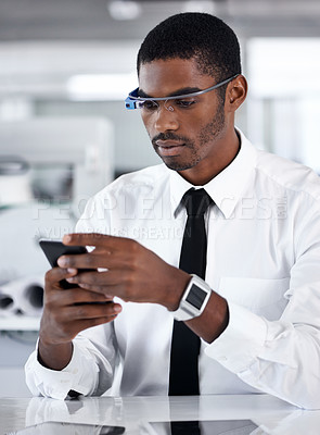 Buy stock photo Cropped shot of a handsome young businessman using smartglasses in his office