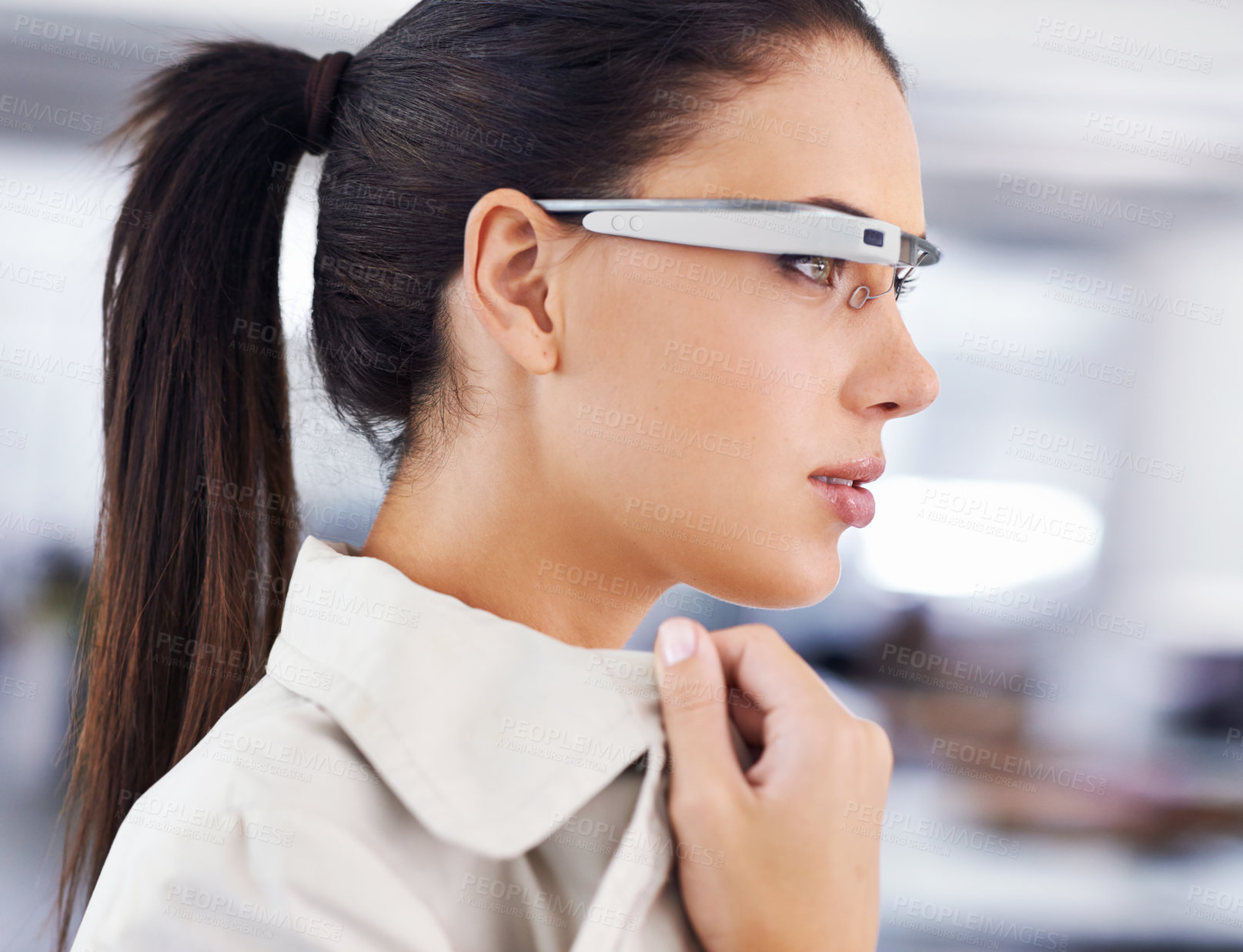 Buy stock photo Cropped shot of an attractive young businesswoman using smartglasses in her office