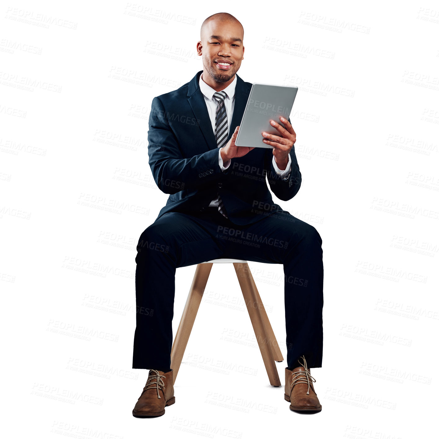 Buy stock photo Studio shot of a handsome young businessman using a tablet against a white background