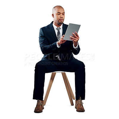 Buy stock photo Studio shot of a handsome young businessman using a tablet against a white background