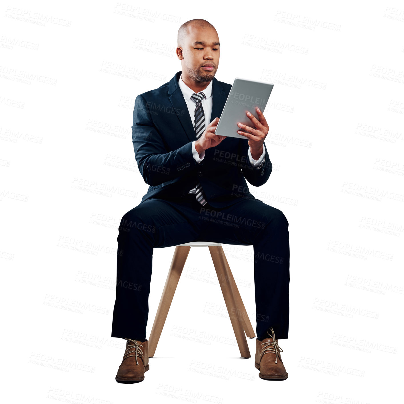 Buy stock photo Studio shot of a handsome young businessman using a tablet against a white background