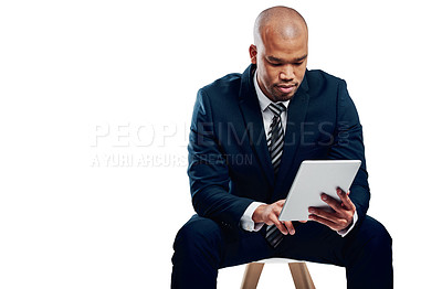 Buy stock photo Studio shot of a handsome young businessman using a tablet against a white background