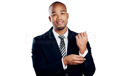 Buy stock photo Studio shot of a handsome young businessman fixing his sleeve against a white background