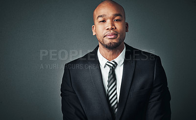 Buy stock photo Studio shot of a handsome young businessman posing against a gray background