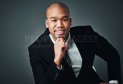 Buy stock photo Studio shot of a handsome young businessman posing against a gray background