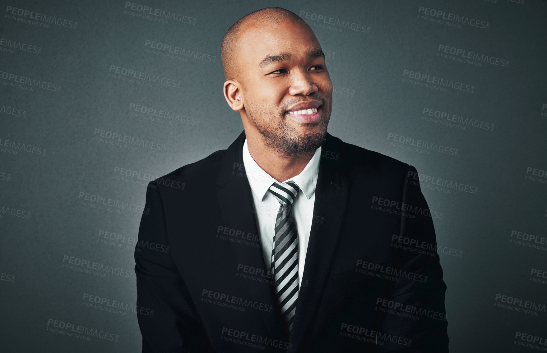 Buy stock photo Studio shot of a handsome young businessman posing against a gray background