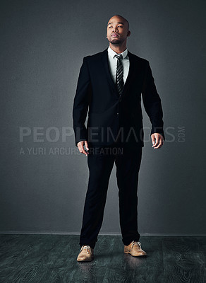 Buy stock photo Studio shot of a handsome young businessman posing against a gray background