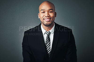 Buy stock photo Studio shot of a handsome young businessman posing against a gray background