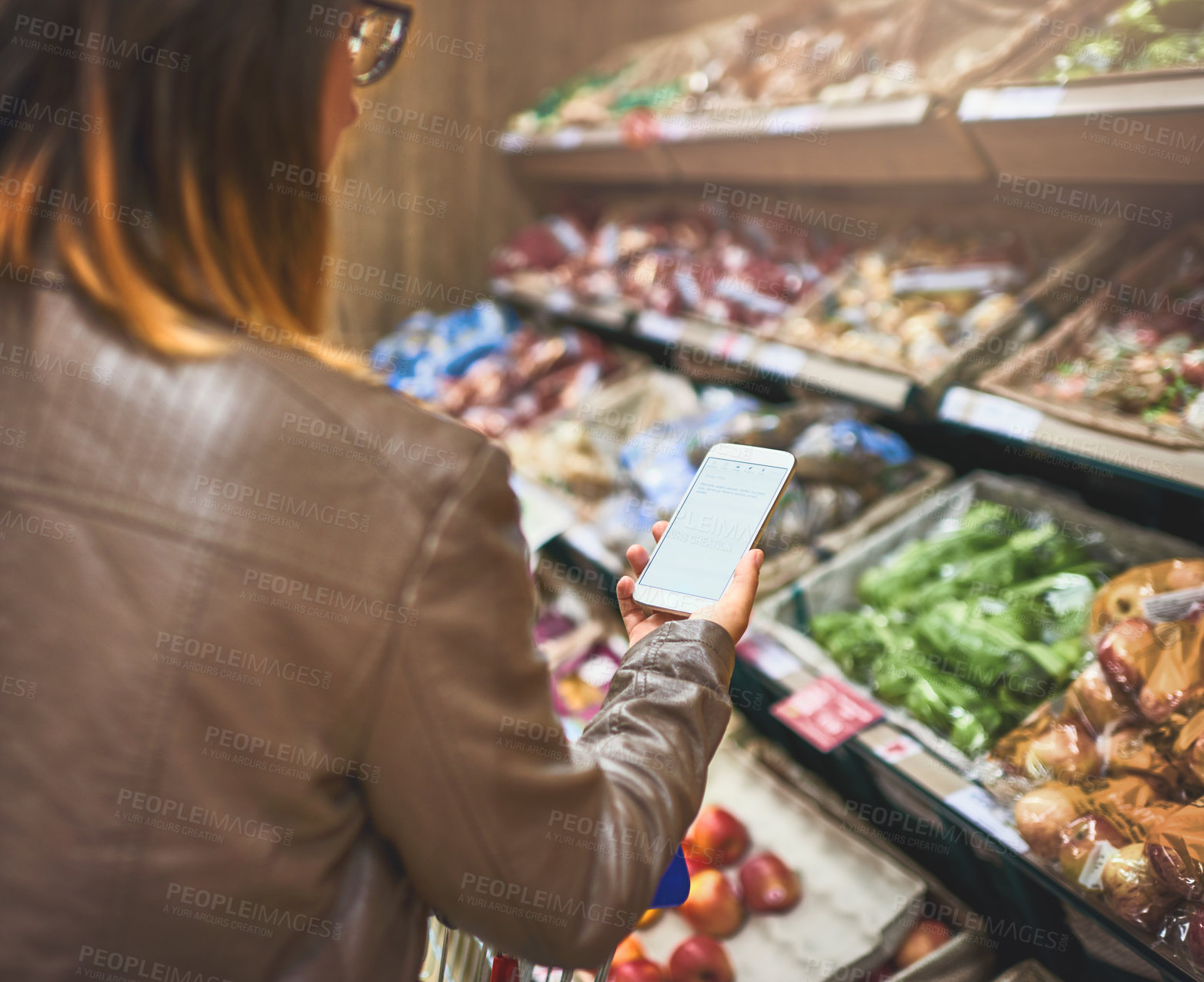 Buy stock photo Customer, woman and shopping list  at grocery store on smartphone in shelf for food and product. Female person, aisle and supermarket or convenience shop for retail cost, prices and discount