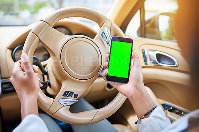 Buy stock photo Shot of an unrecognizable businesswoman using her cellphone while driving to work on her morning commute