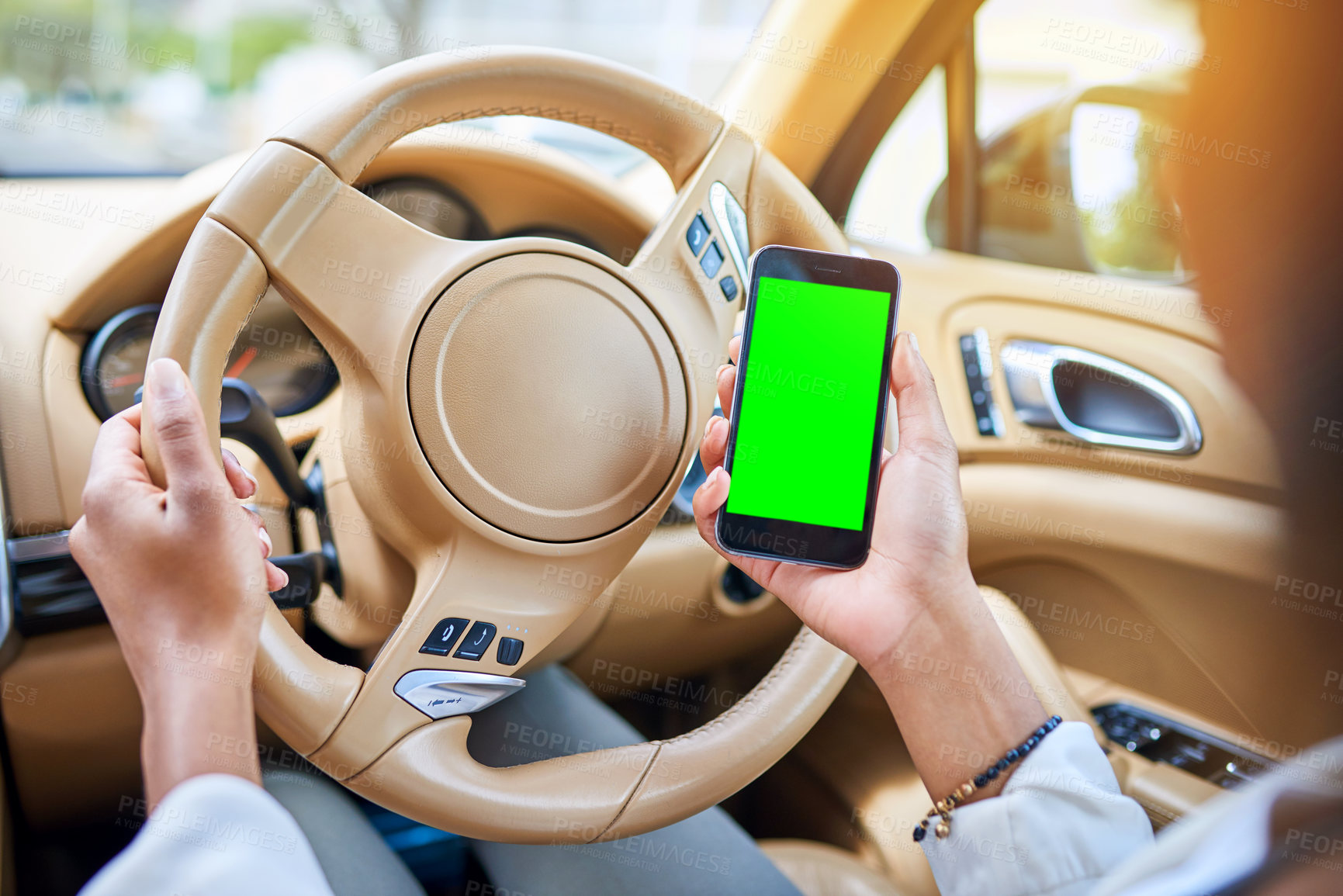 Buy stock photo Shot of an unrecognizable businesswoman using her cellphone while driving to work on her morning commute