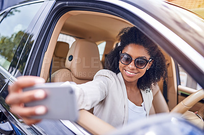 Buy stock photo Cropped shot of an attractive young businesswoman taking selfies while driving to work on her morning commute