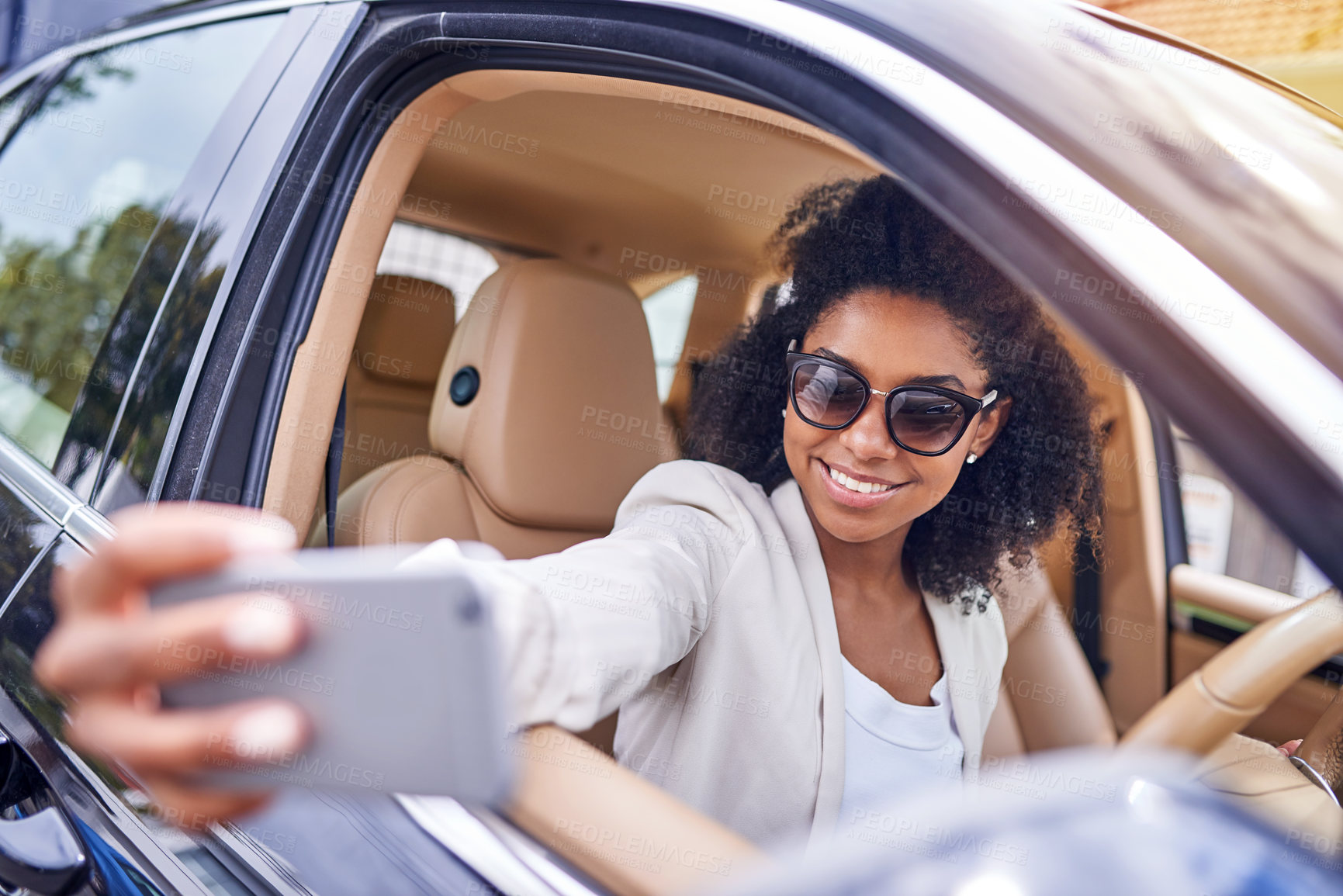 Buy stock photo Cropped shot of an attractive young businesswoman taking selfies while driving to work on her morning commute