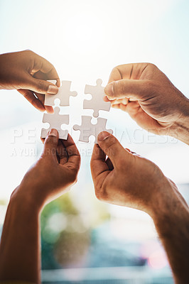 Buy stock photo Cropped shot of businesspeople completing a puzzle together in a modern office