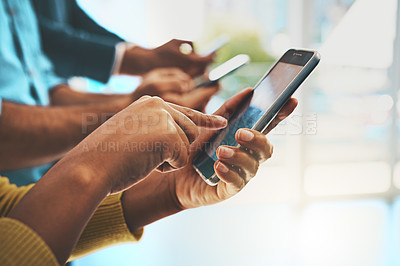 Buy stock photo Cropped shot of unrecognizable businesspeople using their cellphones in the office