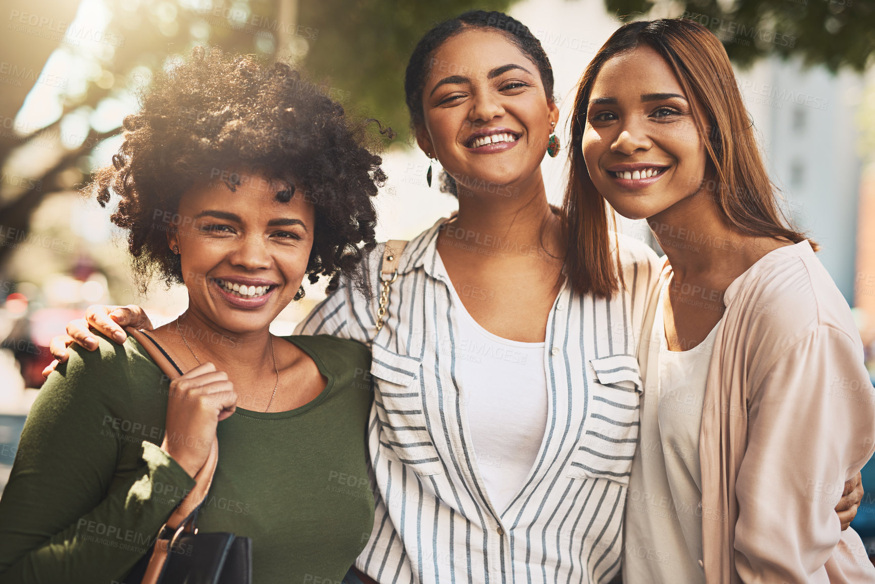 Buy stock photo Portrait of a cheerful young group of friends standing together while looking at the camera outside during the day