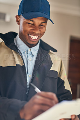 Buy stock photo Shot of a courier writing notes while making a delivery