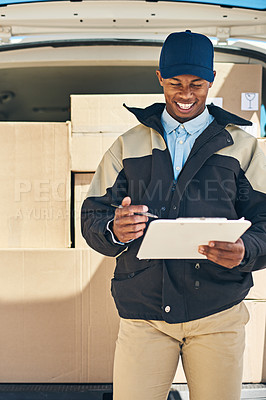 Buy stock photo Shot of a courier checking the deliveries in his van