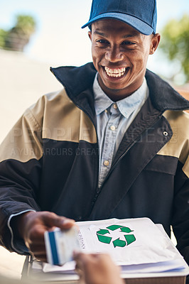 Buy stock photo Shot of a courier accepting a credit card payment from a customer for a delivery