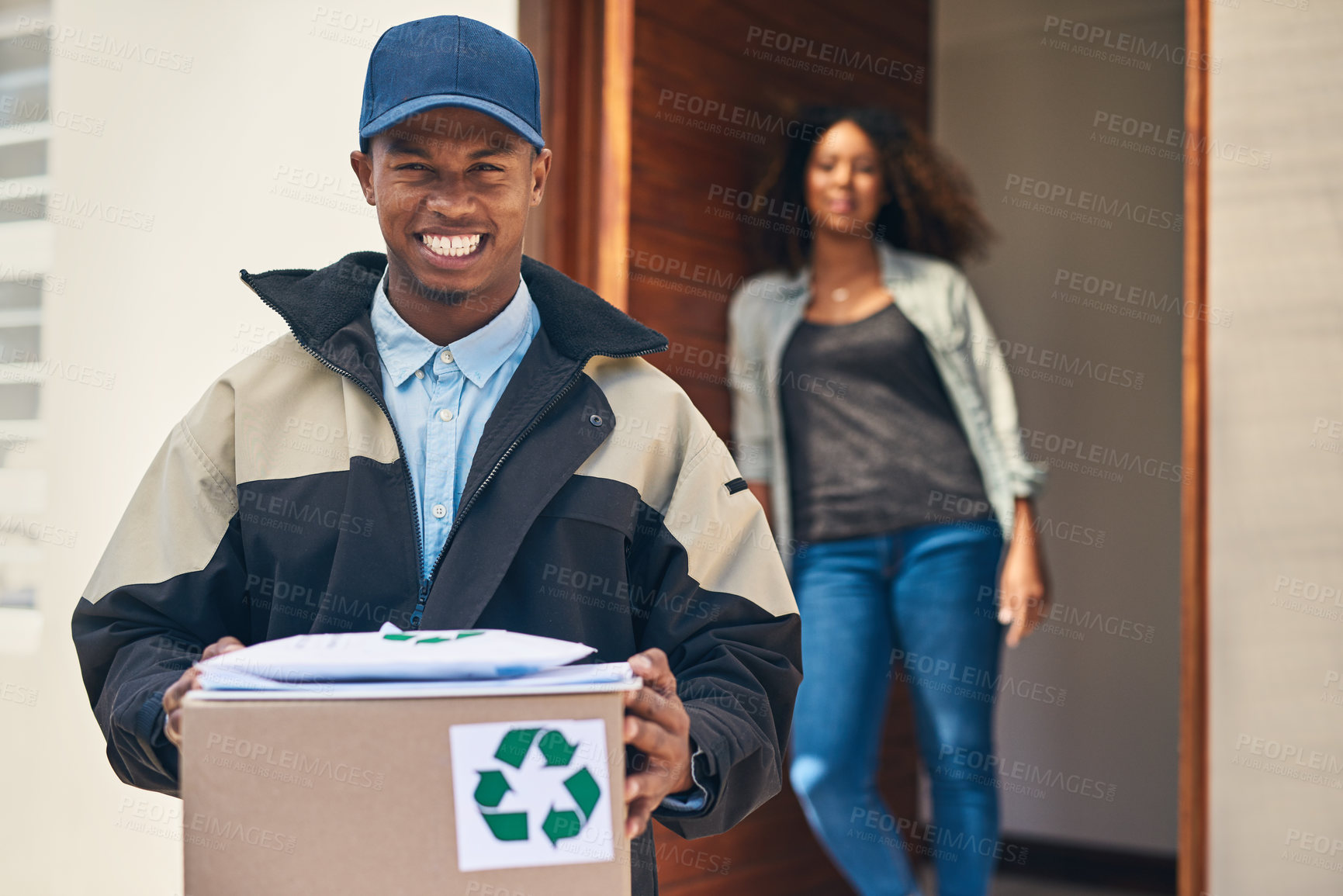 Buy stock photo Portrait of a courier making a home delivery to a customer