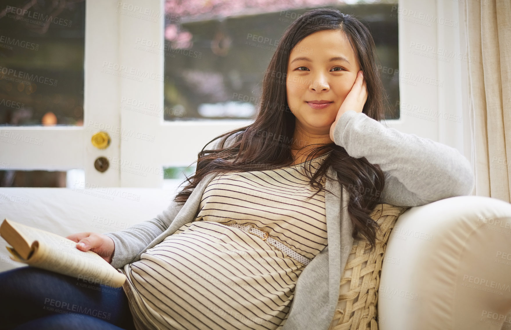 Buy stock photo Portrait of a pregnant woman reading a book at home