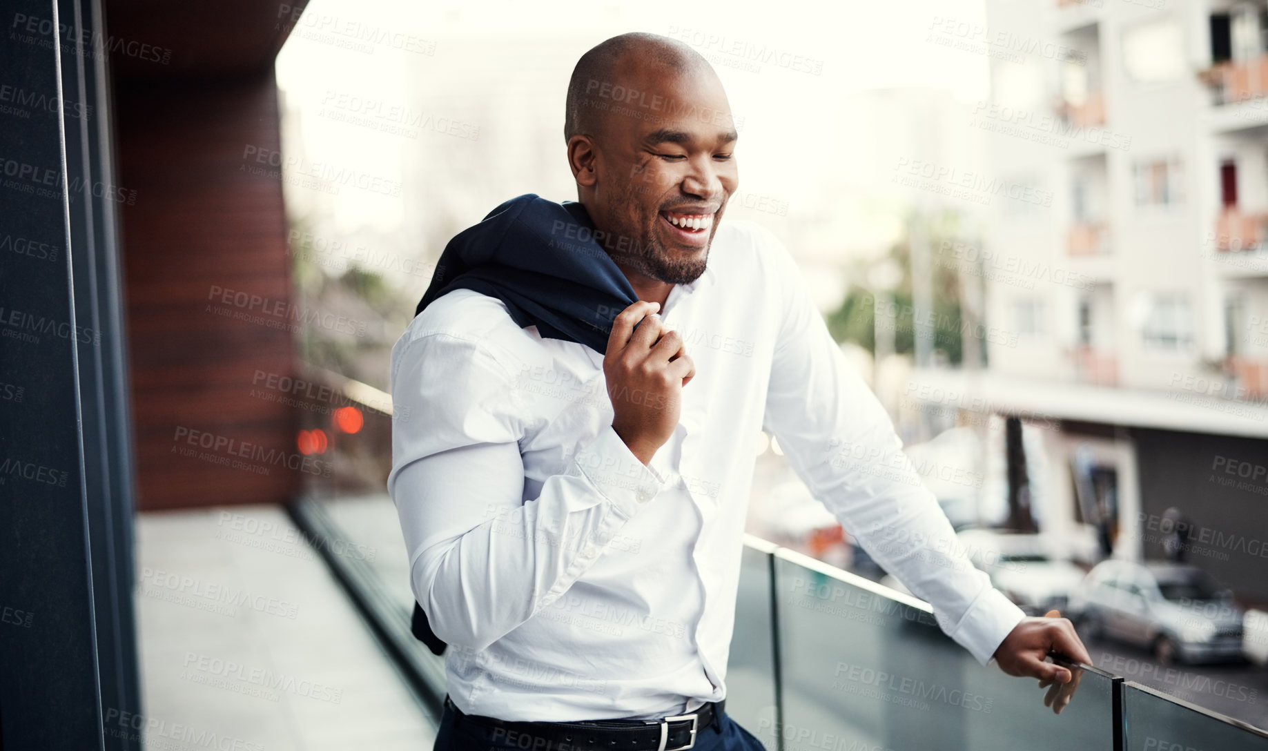 Buy stock photo Shot of a young businessman standing outside on the balcony of an office