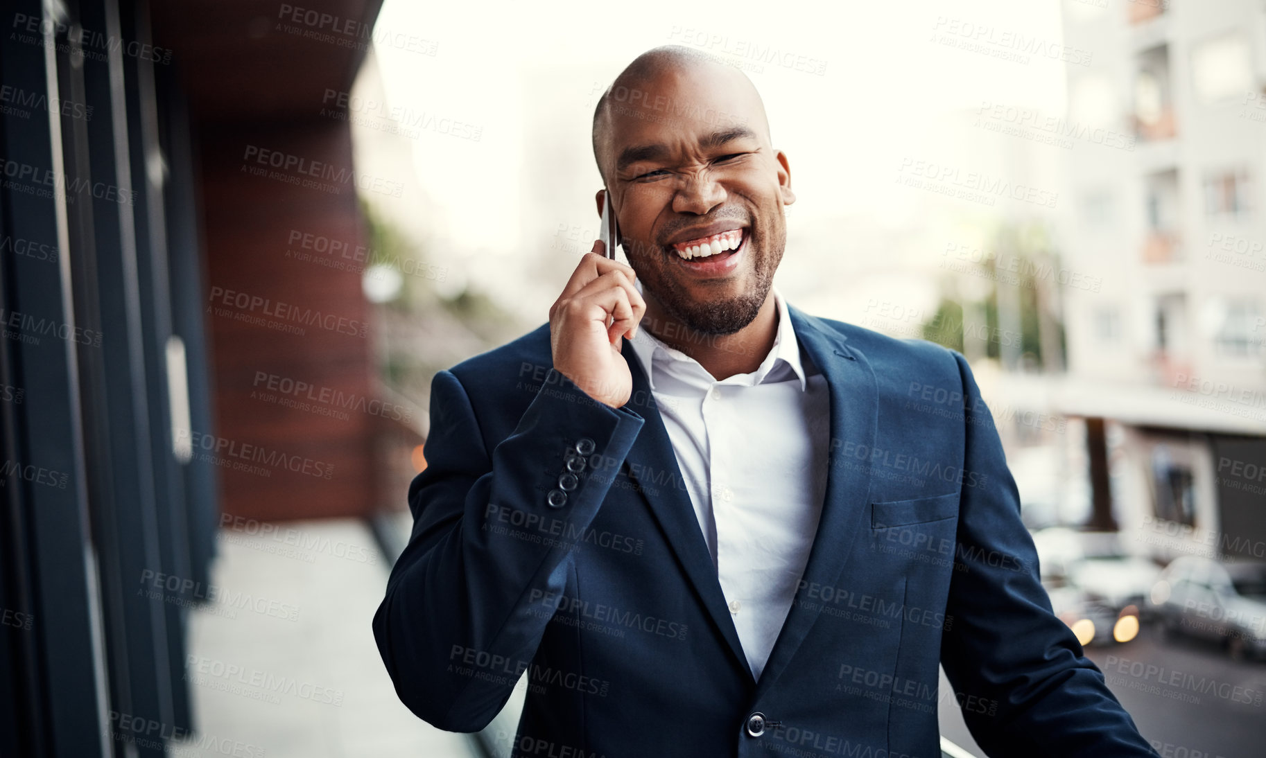 Buy stock photo Portrait of a handsome young businessman talking on a cellphone outside his office