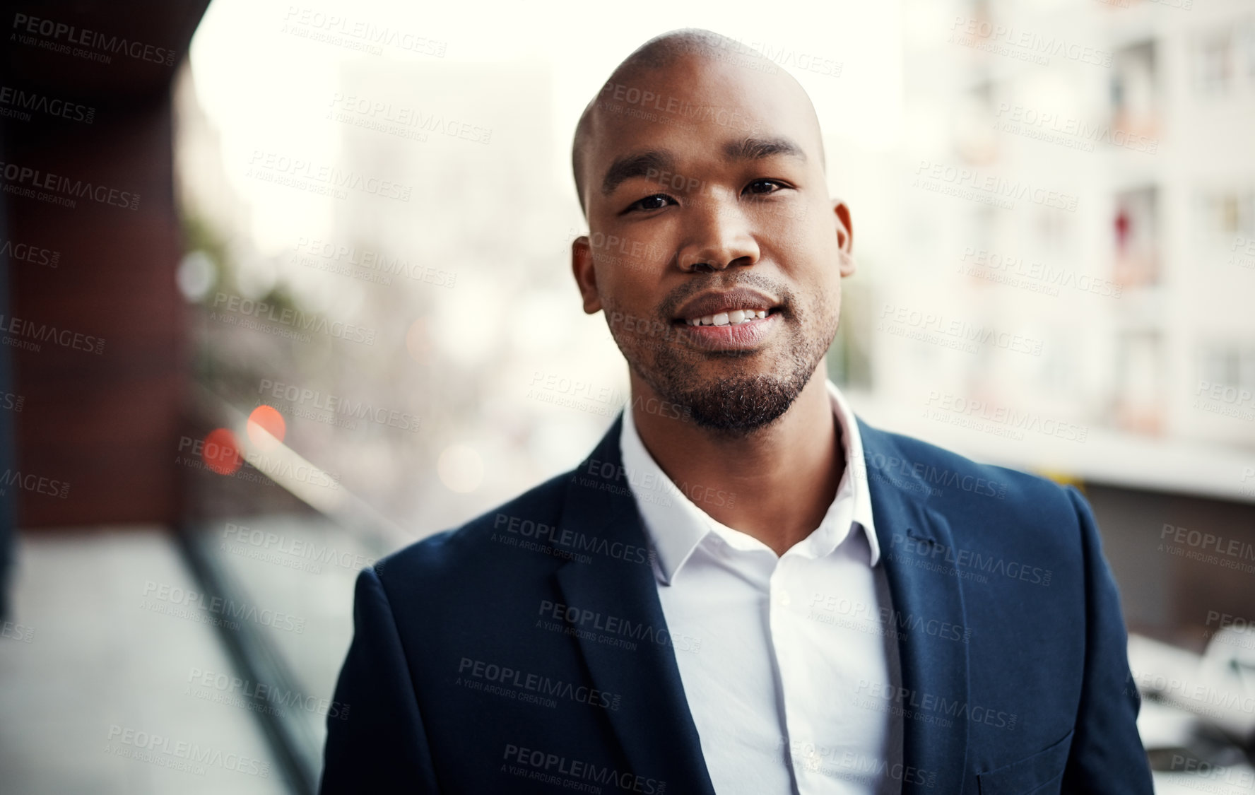 Buy stock photo Portrait of a handsome young businessman standing outside on his office balcony